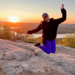 Hiker Jumping on Mountaintop